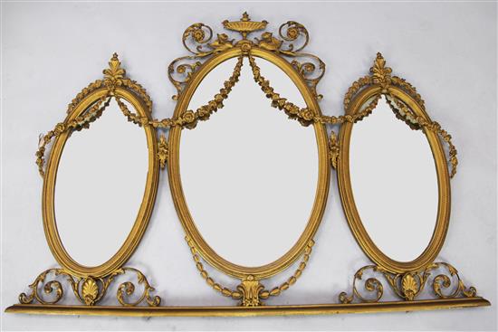 An ornate Adam design gilded three oval bevelled plate overmantel, W. 4ft 8in. H. 3ft 6in.